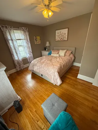 a bedroom with a bed furniture and a chandelier