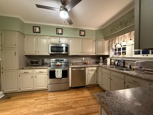 a kitchen with stainless steel appliances granite countertop a stove and a sink