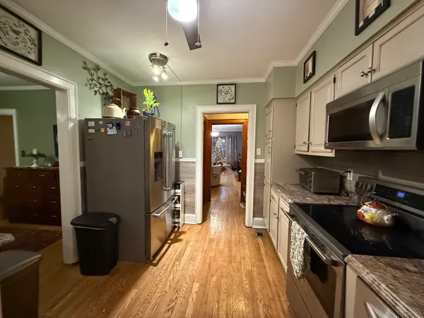 a kitchen with stainless steel appliances granite countertop a refrigerator a stove top oven a sink and dishwasher