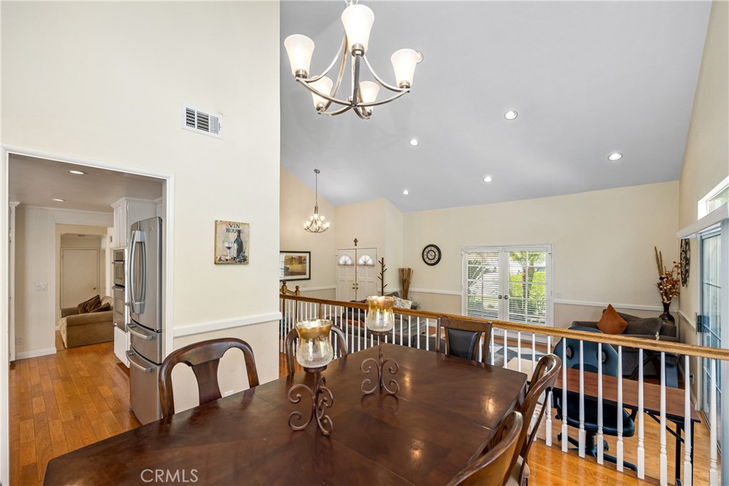 2508 Royale Place Fullerton, CA 92833 - Photo 14 of 53 a dining room with furniture a chandelier and wooden floor