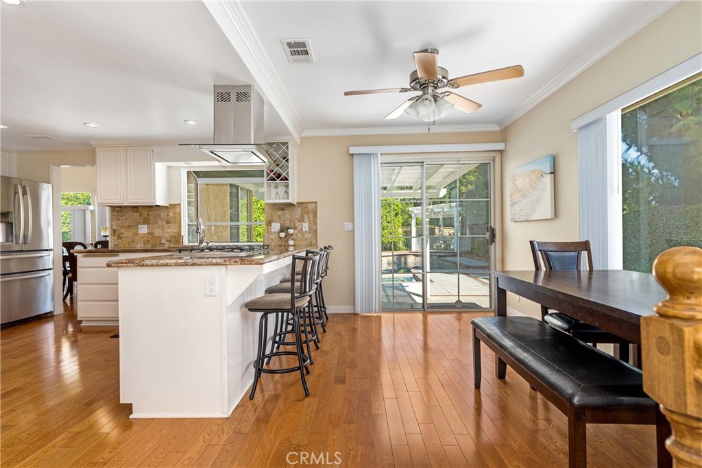 2508 Royale Place Fullerton, CA 92833 - Photo 16 of 53 a view of a dining room with furniture a chandelier and wooden floor