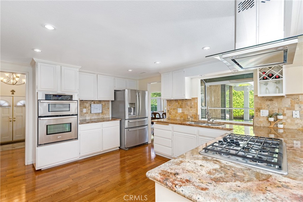 2508 Royale Place Fullerton, CA 92833 - Photo 20 of 53 a kitchen with stainless steel appliances kitchen island granite countertop a sink stove and refrigerator