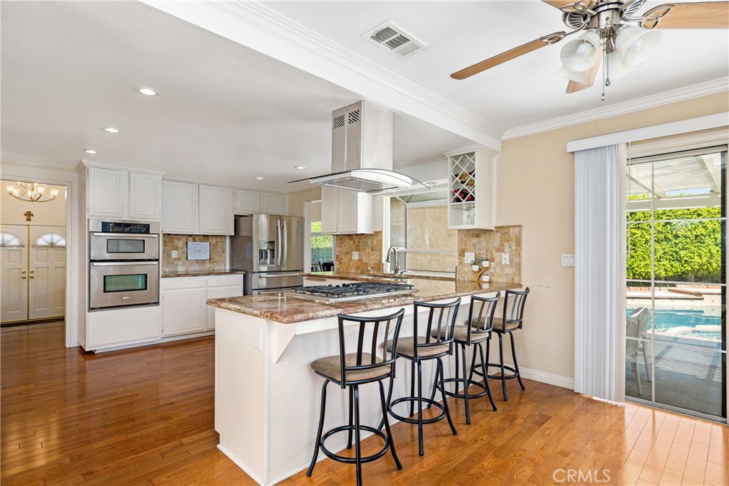 2508 Royale Place Fullerton, CA 92833 - Photo 3 of 53 a kitchen with stainless steel appliances a dining table chairs stove and wooden floor