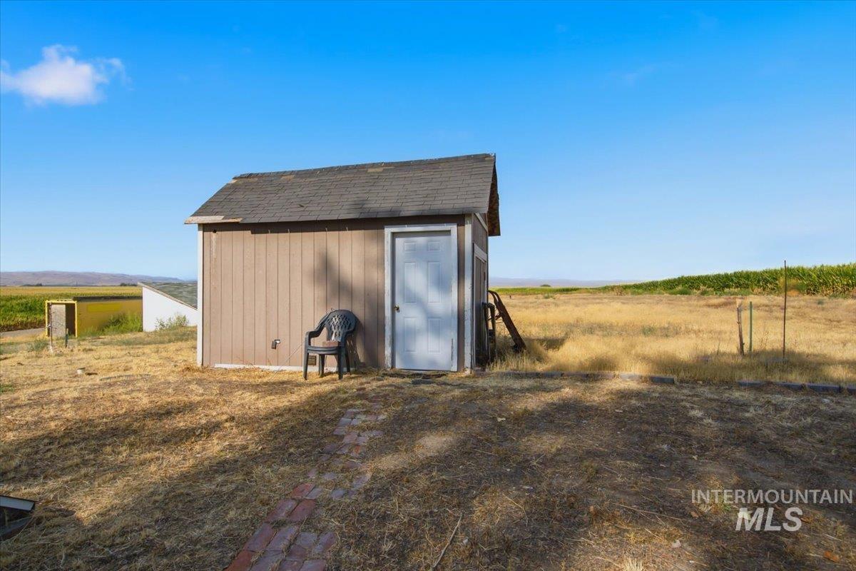3929-3927 Homestead Road Homedale, ID 83628 - Photo 20 of 45 Storage shed with vertical siding and an asphalt shingle roof