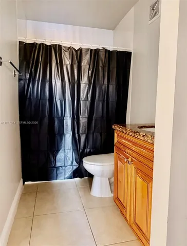 a bathroom with a granite countertop sink and mirror