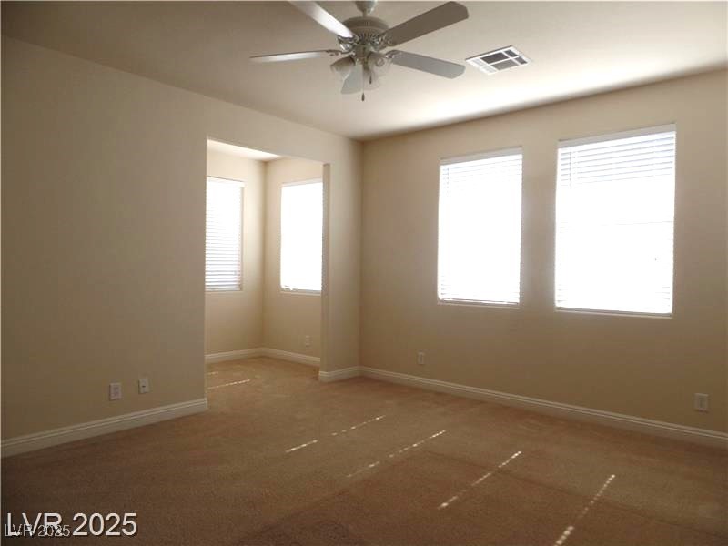 118 Castle Course Avenue Las Vegas, NV 89148 - Photo 12 of 56 Carpeted empty room with plenty of natural light and a ceiling fan
