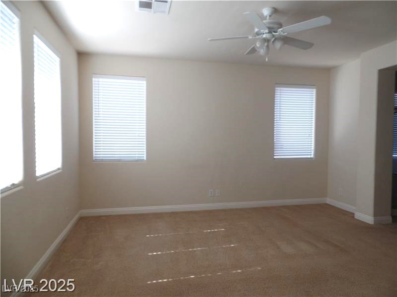 118 Castle Course Avenue Las Vegas, NV 89148 - Photo 13 of 56 Empty room featuring light colored carpet and a ceiling fan