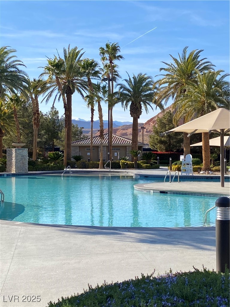 118 Castle Course Avenue Las Vegas, NV 89148 - Photo 25 of 56 Community pool with a patio area and a mountain view