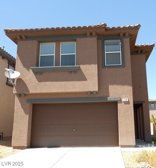 118 Castle Course Avenue Las Vegas, NV 89148 - Photo 4 of 56 Mediterranean / spanish home featuring stucco siding, a tile roof, an attached garage, and concrete driveway