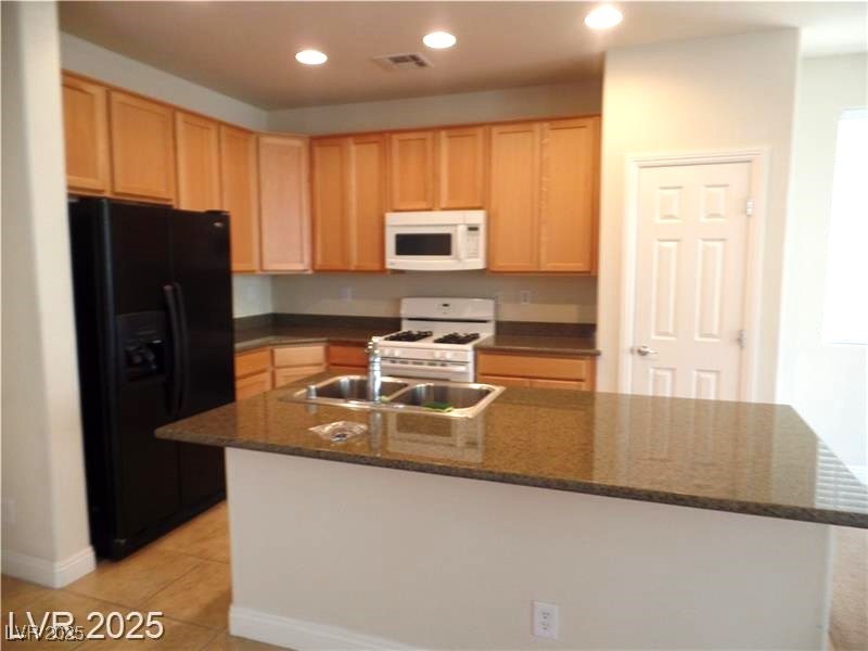 118 Castle Course Avenue Las Vegas, NV 89148 - Photo 5 of 56 Kitchen with white appliances, recessed lighting, a center island with sink, light brown cabinets, and light tile patterned floors