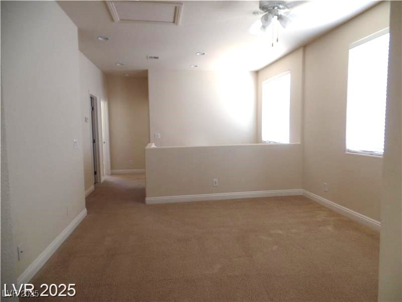 118 Castle Course Avenue Las Vegas, NV 89148 - Photo 10 of 56 Empty room with light colored carpet and a ceiling fan