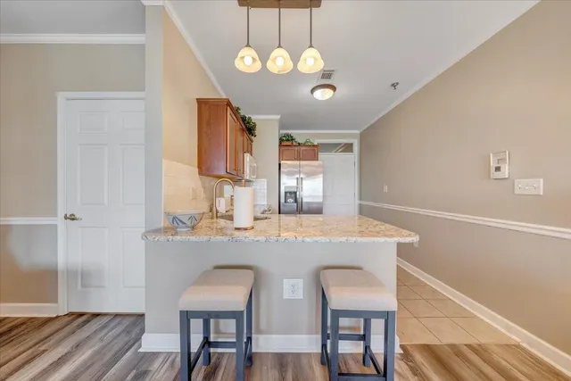 a kitchen with stainless steel appliances granite countertop a refrigerator and a stove top oven