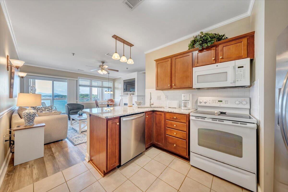 1273 Graves Harbor Trail, Unit 347 Huddleston, VA 24104 - Photo 13 of 63 a kitchen with stainless steel appliances granite countertop a stove and a sink