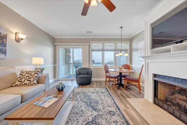 a living room with furniture a flat screen tv and a fireplace