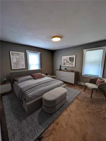 a spacious bedroom with two beds and painting on the wall