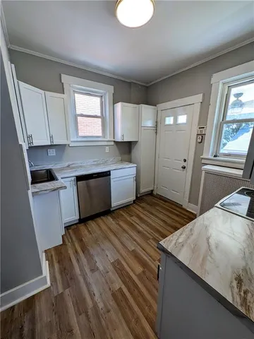 a kitchen with a sink and a stove top oven