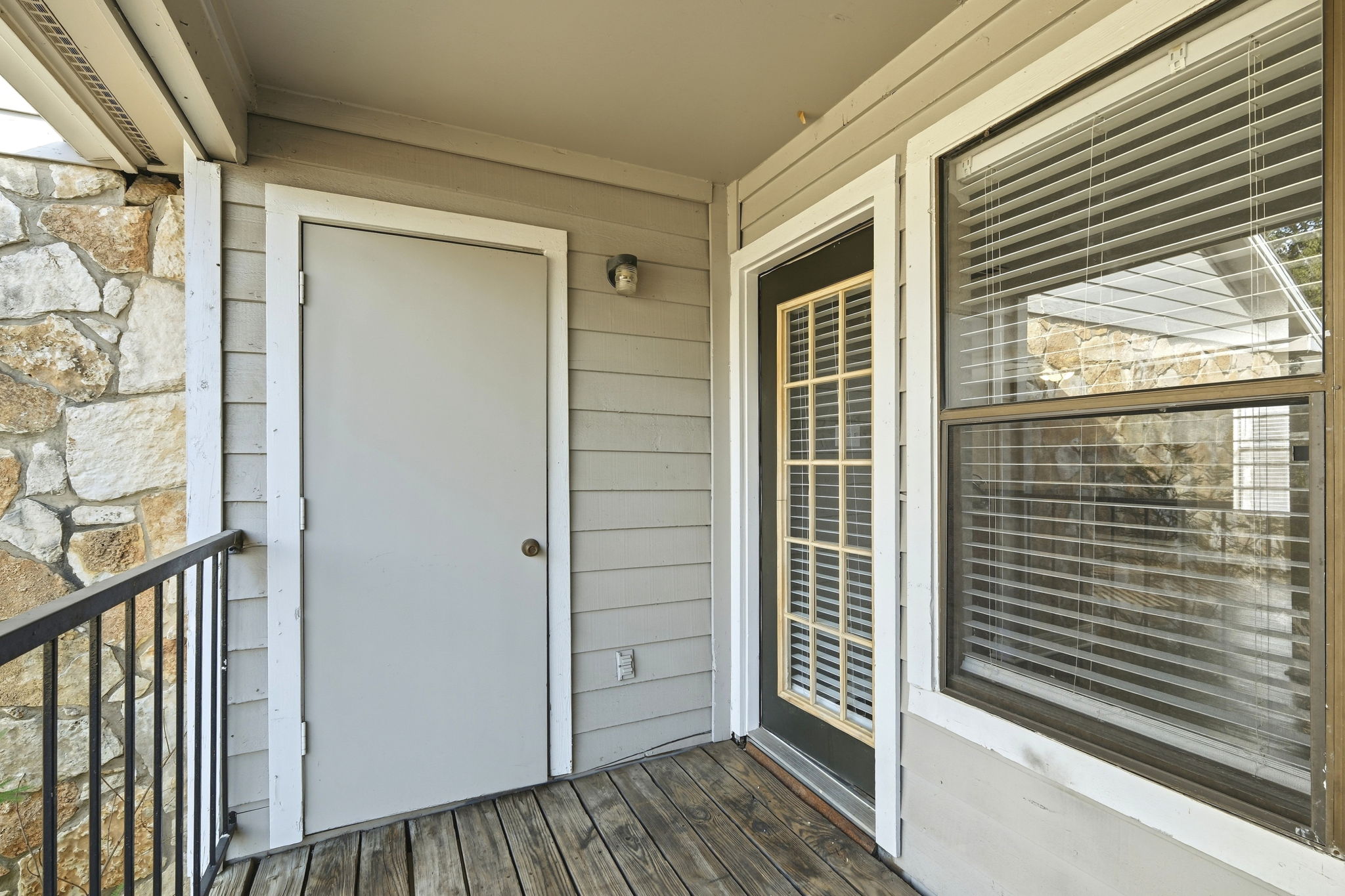 8804 Schick Road, Unit C Austin, TX 78729 - Photo 14 of 17 A private covered balcony features classic wood plank flooring and a secure storage closet.