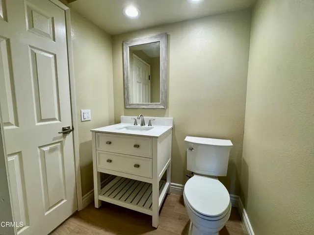 a bathroom with a toilet a sink and a mirror
