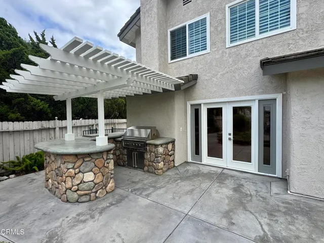 a view of a house with swimming pool and furniture