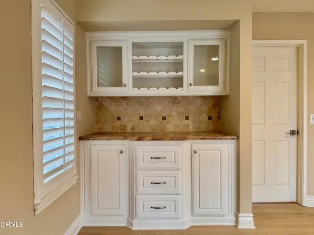 a bathroom with a granite countertop mirror and a sink