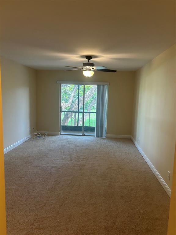4116 Northwest 88th Avenue, Unit 202 Coral Springs, FL 33065 - Photo 12 of 16 an empty room with windows and ceiling fan