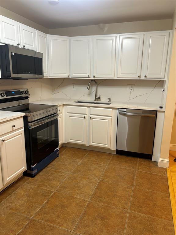 4116 Northwest 88th Avenue, Unit 202 Coral Springs, FL 33065 - Photo 2 of 16 a kitchen with stainless steel appliances granite countertop a stove a sink and a microwave
