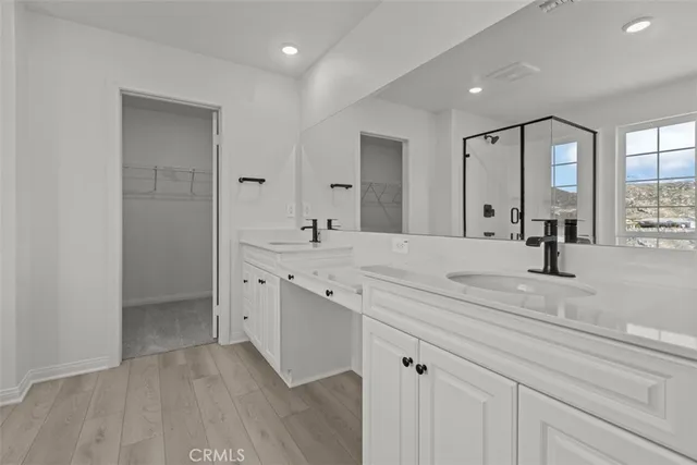 a spacious bathroom with a double vanity sink and mirror