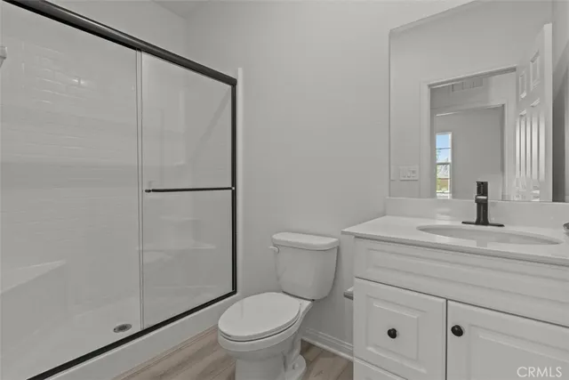 a bathroom with a toilet a sink and shower