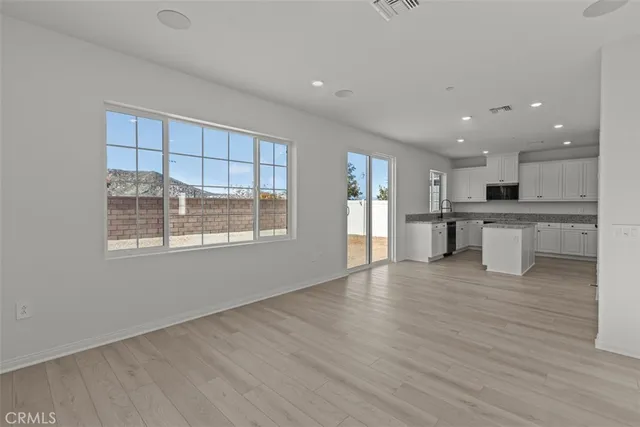a view of kitchen with wooden floor and windows