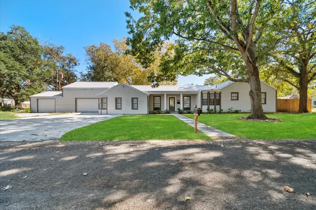 a view of house with a yard