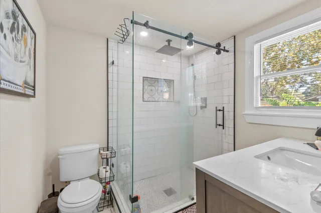 a bathroom with a sink toilet and shower