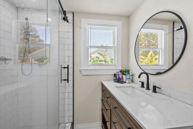 a bathroom with a sink a toilet and a mirror