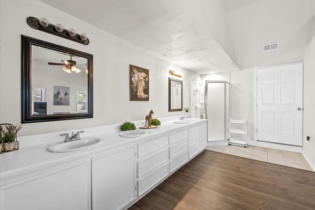 a bathroom with a double vanity sink and mirror