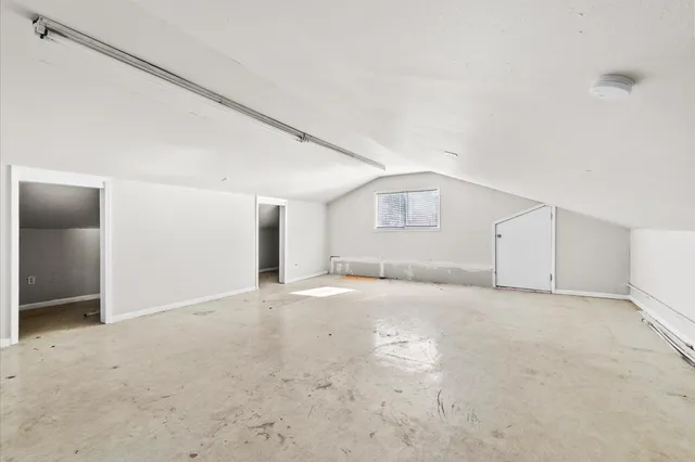 an empty room with a empty space and windows