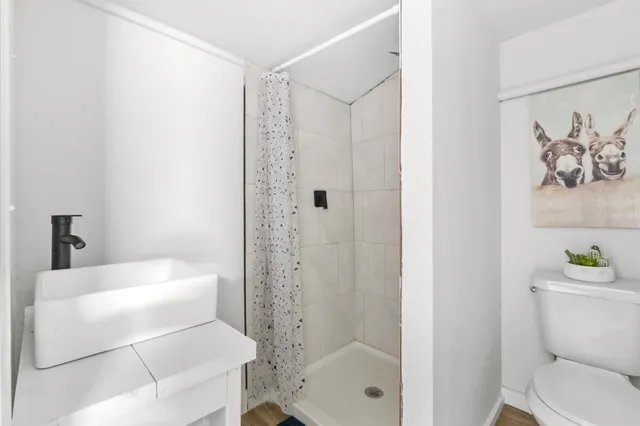 a bathroom with a bathtub a toilet and a shower