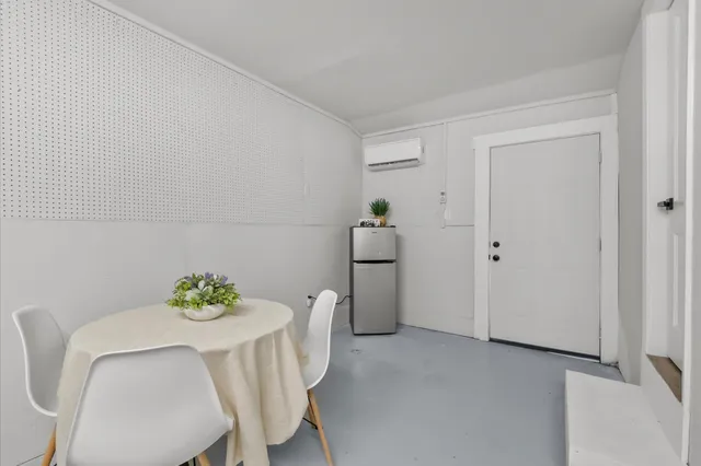 a dining room with furniture and wooden floor