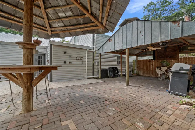 a view of a backyard with furniture and a garage