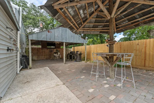 a view of a chairs and table in backyard
