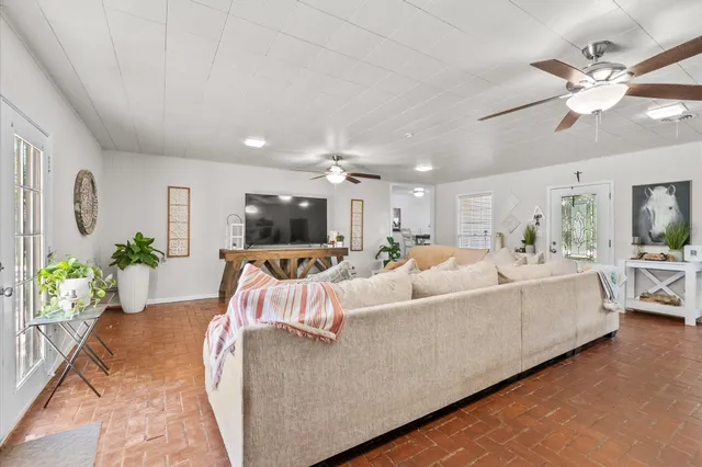 a living room with furniture and a chandelier