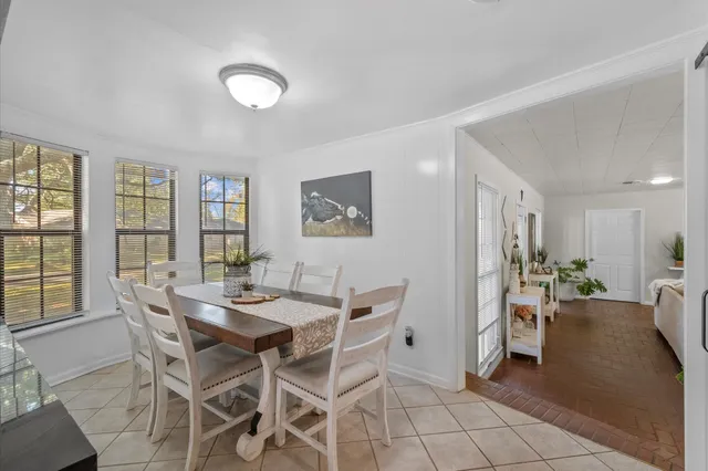 a view of a dining room with furniture and a potted plant