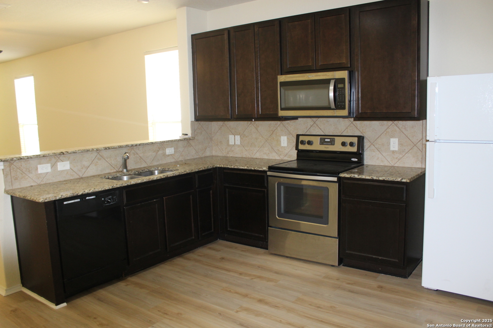 482 Walnut Crest Selma, TX 78154 - Photo 8 of 19 a kitchen with a sink stove and microwave