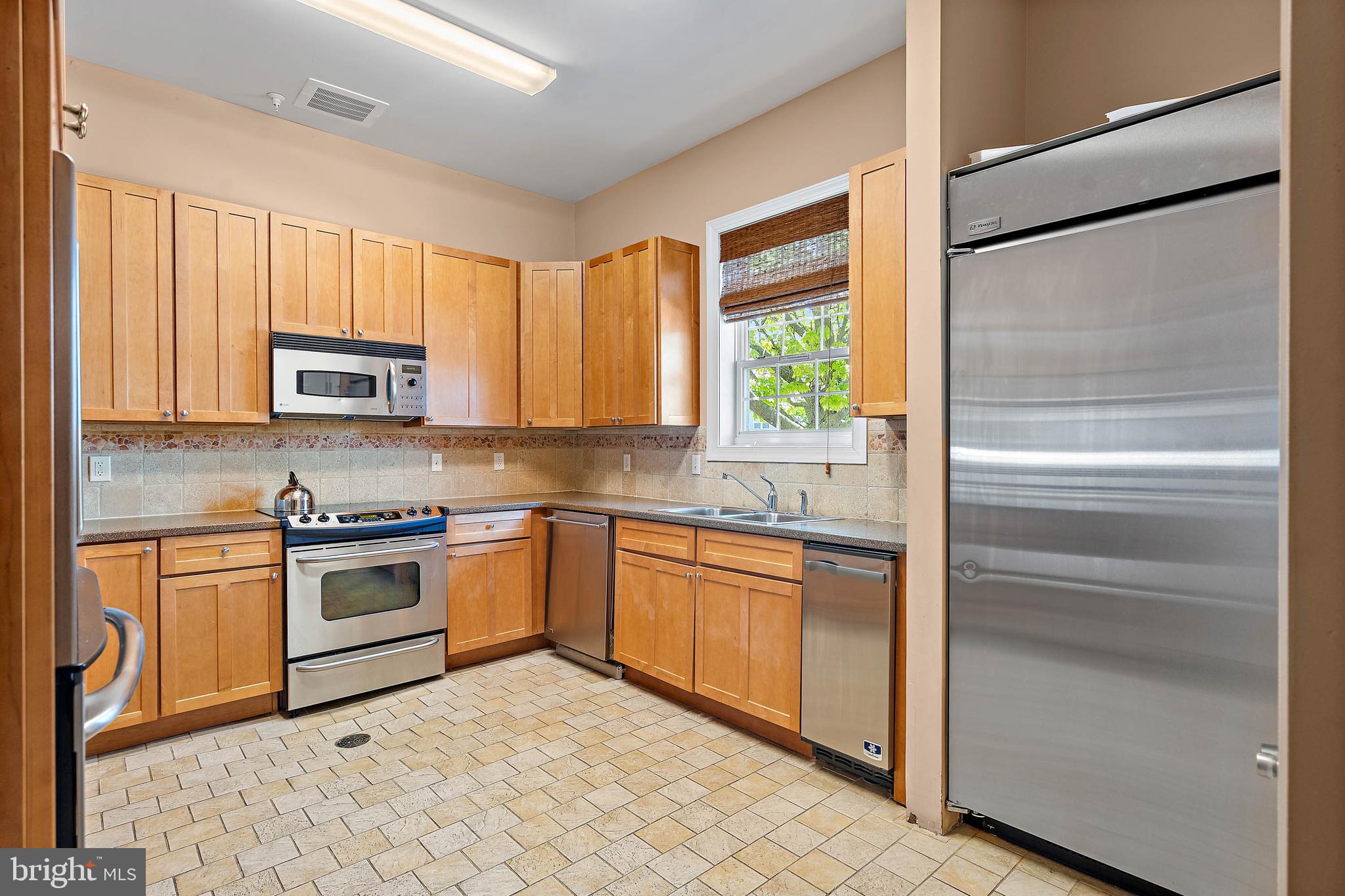 12159 Snug Harbor Road Berlin, MD 21811 - Photo 60 of 72 a kitchen with granite countertop stainless steel appliances and window