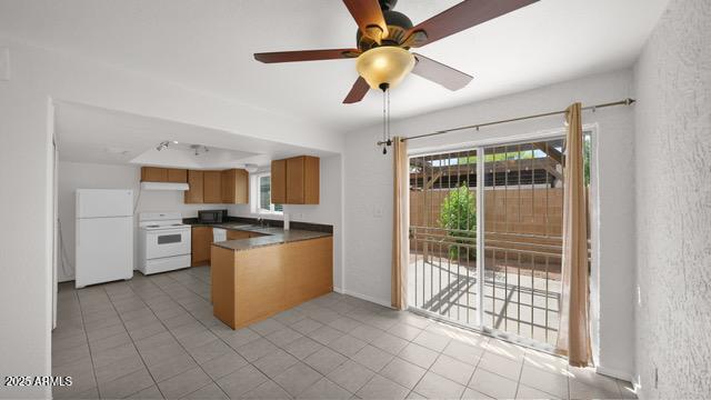 8249 East Thomas Road Scottsdale, AZ 85251 - Photo 2 of 8 a kitchen with stainless steel appliances kitchen island granite countertop a stove a sink and a refrigerator