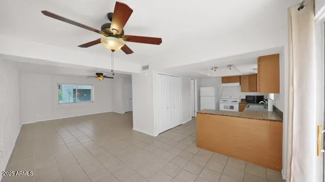 a kitchen with a sink window and cabinets