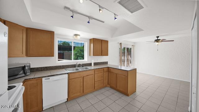 8249 East Thomas Road Scottsdale, AZ 85251 - Photo 4 of 8 a kitchen with a sink window and cabinets