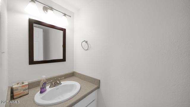 8249 East Thomas Road Scottsdale, AZ 85251 - Photo 6 of 8 a bathroom with a sink and a mirror