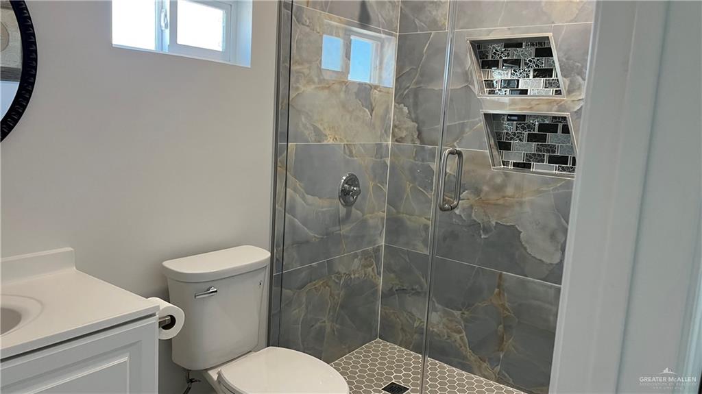 318 Sun Dial Circle Port Isabel, TX 78578 - Photo 13 of 19 a bathroom with a toilet and a shower