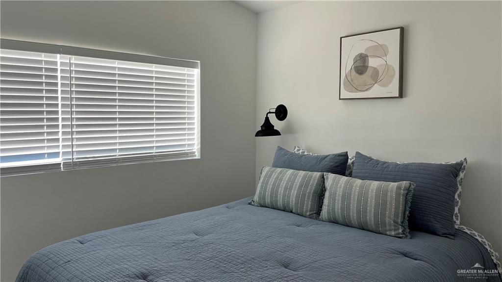 318 Sun Dial Circle Port Isabel, TX 78578 - Photo 16 of 19 a bed sitting in a bedroom next to a window