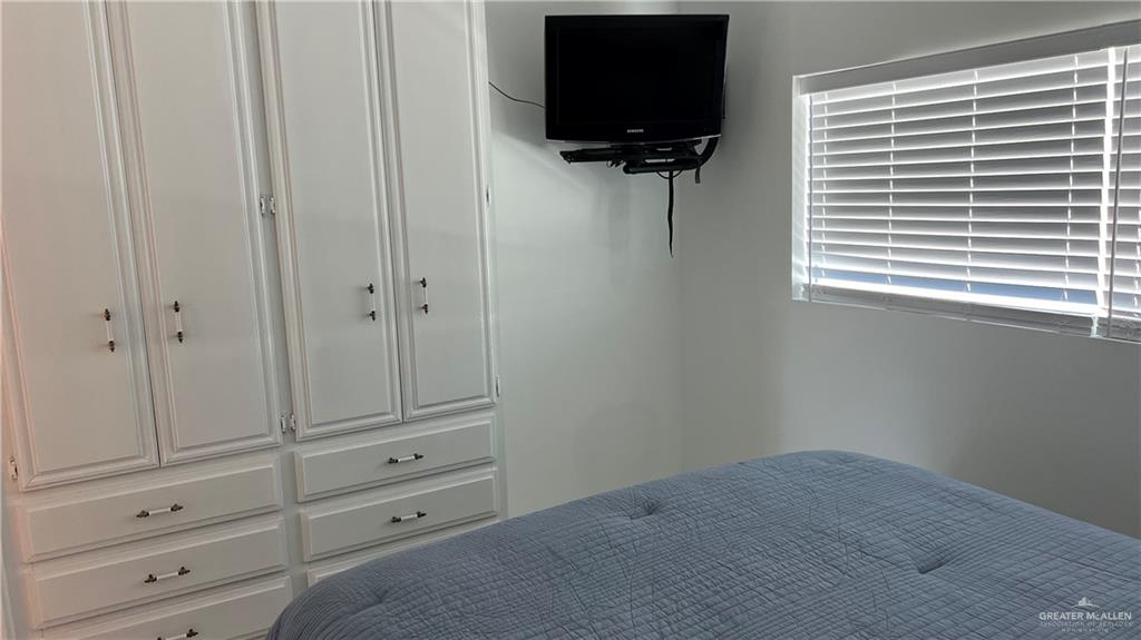 318 Sun Dial Circle Port Isabel, TX 78578 - Photo 18 of 19 a room with a flat screen tv and a window