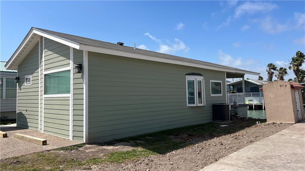 318 Sun Dial Circle Port Isabel, TX 78578 - Photo 2 of 19 a back view of a house with a yard